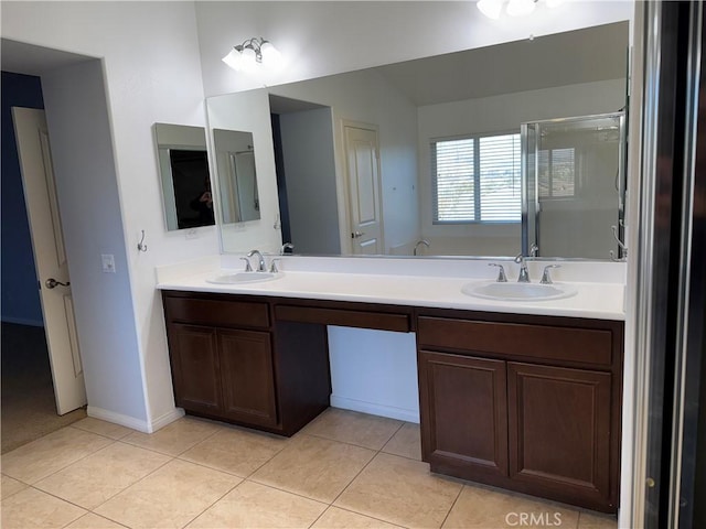 bathroom with vanity, a shower with door, vaulted ceiling, and tile patterned floors