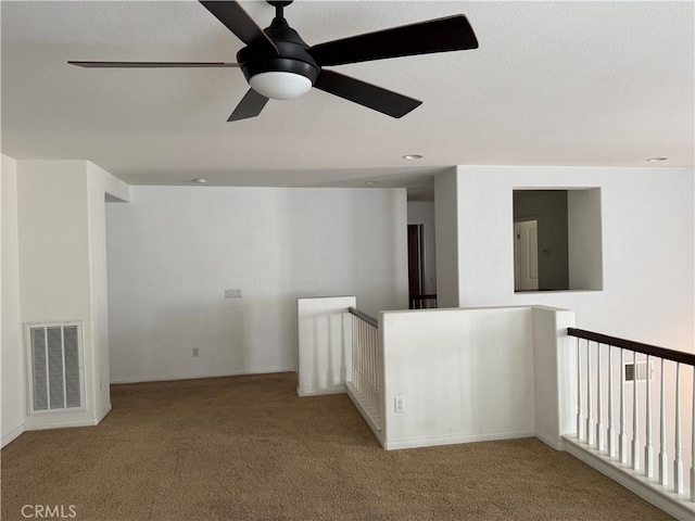 empty room with light colored carpet and ceiling fan