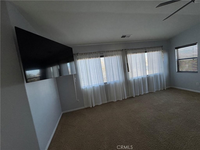 unfurnished room with carpet floors and ceiling fan