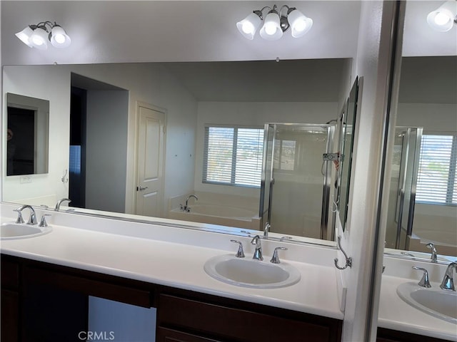 bathroom featuring vanity, a wealth of natural light, and separate shower and tub