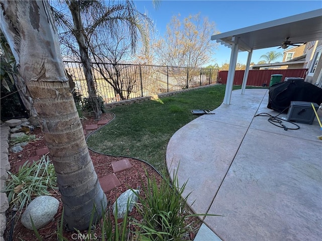 view of yard with ceiling fan and a patio area