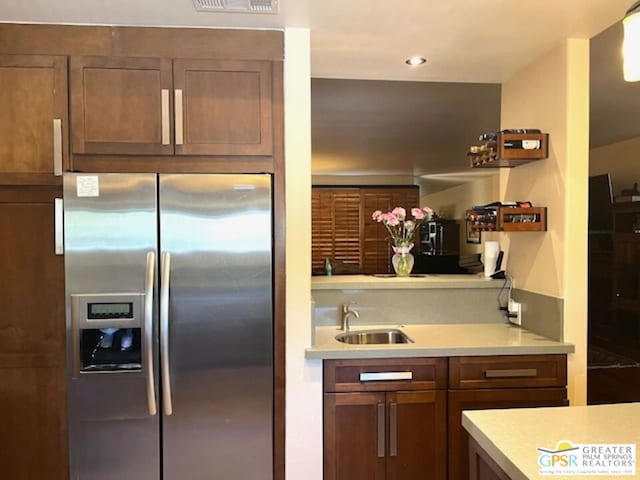 kitchen featuring sink and stainless steel fridge