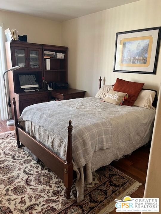 bedroom with hardwood / wood-style floors