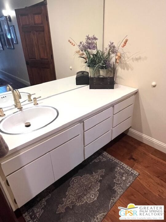 bathroom with vanity and hardwood / wood-style floors