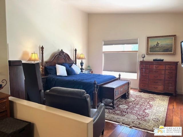 bedroom with dark hardwood / wood-style flooring