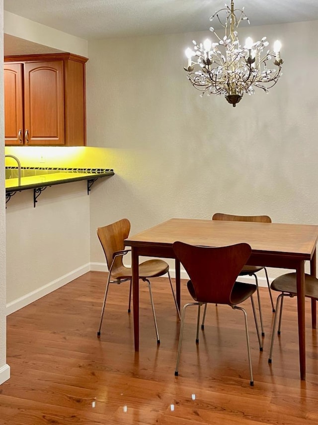 dining room featuring hardwood / wood-style flooring and a notable chandelier