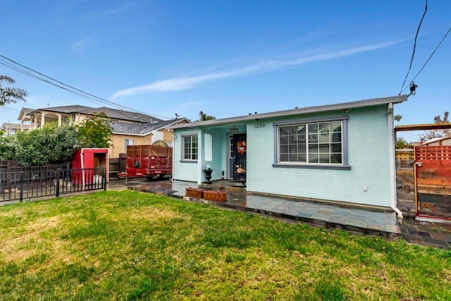 back of property featuring a yard