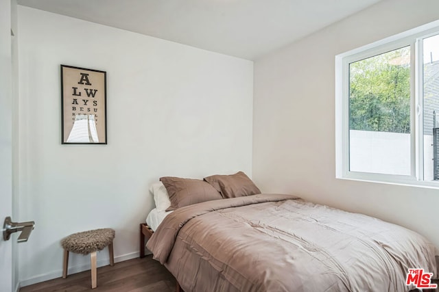 bedroom with hardwood / wood-style flooring