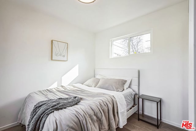 bedroom featuring dark hardwood / wood-style flooring