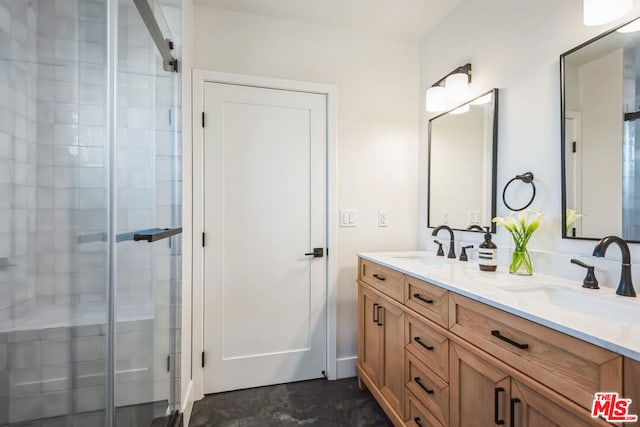 bathroom with vanity and a shower with door