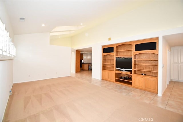 unfurnished living room featuring lofted ceiling and light carpet