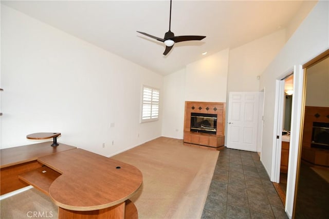 carpeted living room with lofted ceiling, a fireplace, and ceiling fan