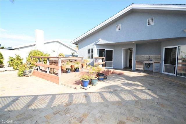 back of property with a patio