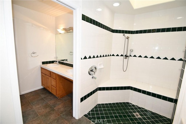 bathroom featuring sink and a tile shower