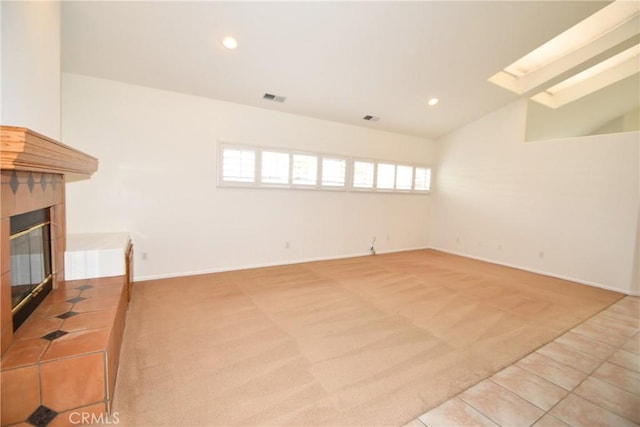 carpeted living room with vaulted ceiling and a fireplace