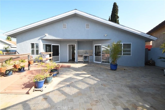 rear view of property with a patio area