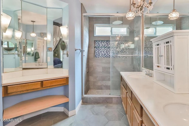 bathroom with tile patterned floors, vanity, plenty of natural light, and a tile shower