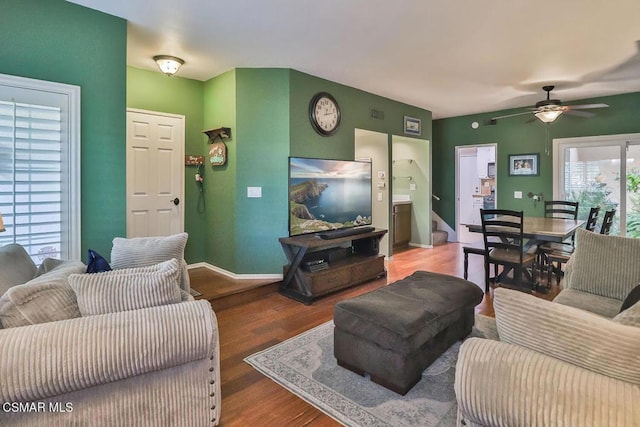 living room featuring ceiling fan and wood-type flooring