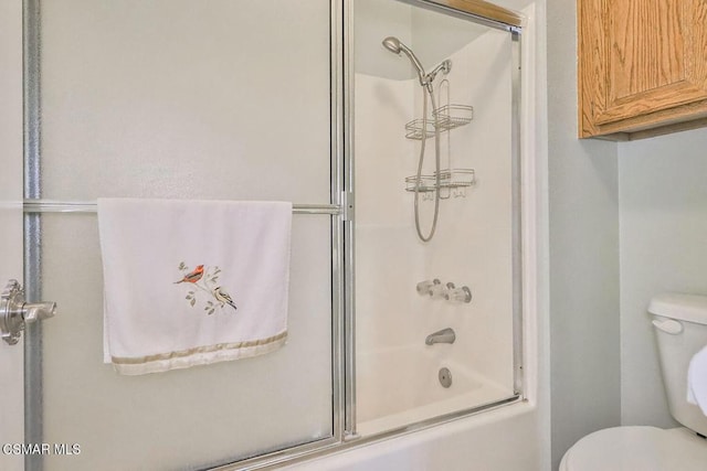 bathroom with enclosed tub / shower combo and toilet