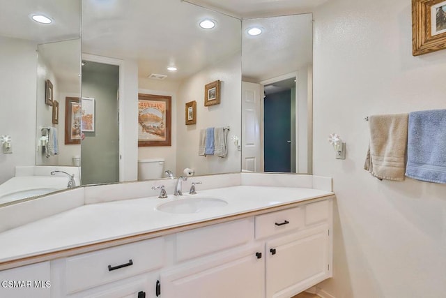 bathroom featuring vanity and toilet