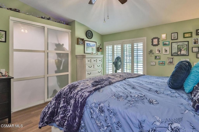 bedroom featuring hardwood / wood-style flooring, lofted ceiling, and ceiling fan