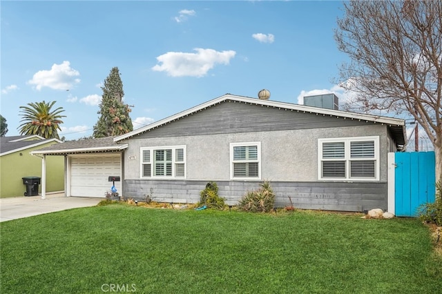 view of front of home featuring a garage and a front lawn