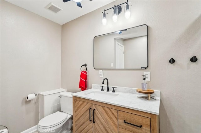 bathroom featuring vanity, ceiling fan, and toilet