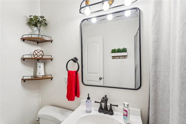 bathroom with sink and toilet