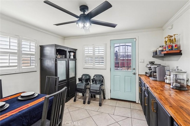 dining space featuring ornamental molding, ceiling fan, and light tile patterned flooring