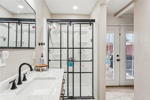 bathroom featuring vanity, french doors, and walk in shower