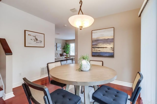 dining room with dark wood-type flooring