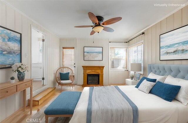 bedroom with crown molding, light hardwood / wood-style flooring, and ceiling fan