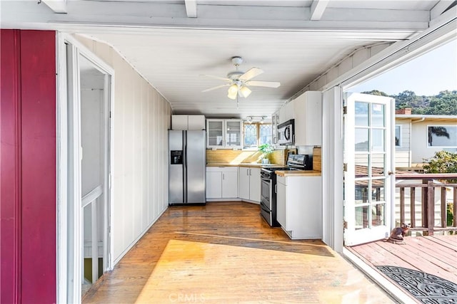 kitchen featuring white cabinetry, hardwood / wood-style flooring, stainless steel appliances, and ceiling fan