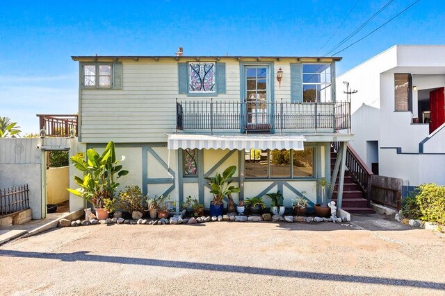 view of front of property with a balcony