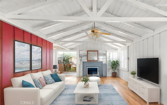 living room featuring ceiling fan, light hardwood / wood-style floors, lofted ceiling with beams, and wooden ceiling