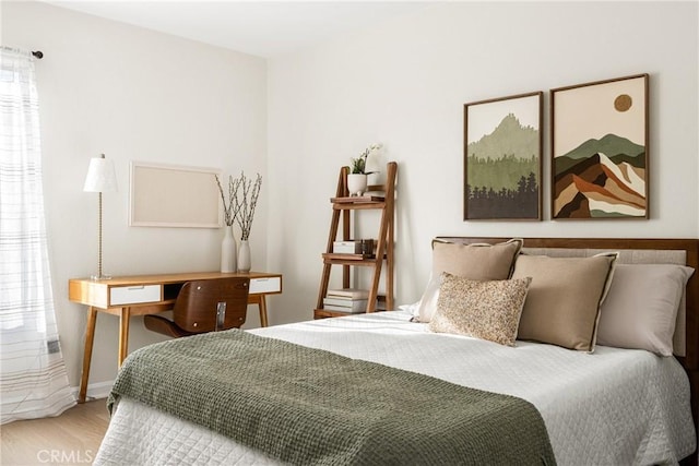 bedroom featuring wood-type flooring and multiple windows