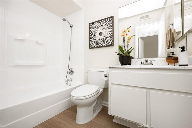 full bathroom with vanity, wood-type flooring, bathing tub / shower combination, and toilet