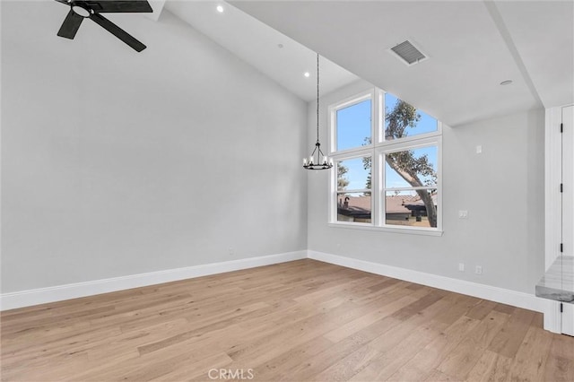 additional living space with high vaulted ceiling, ceiling fan with notable chandelier, and light hardwood / wood-style flooring