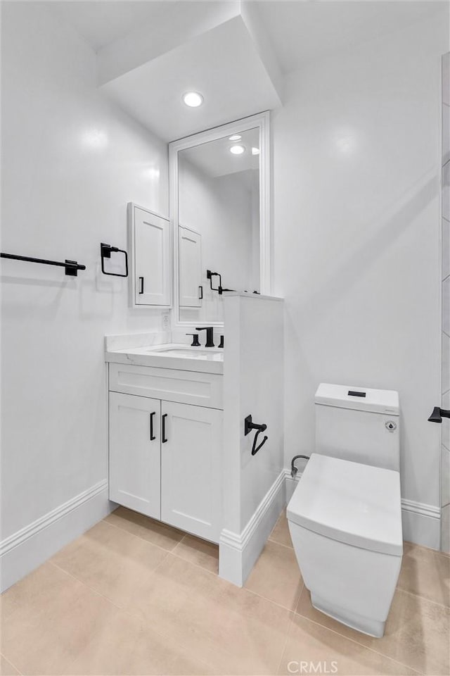 bathroom with tile patterned flooring, vanity, and toilet