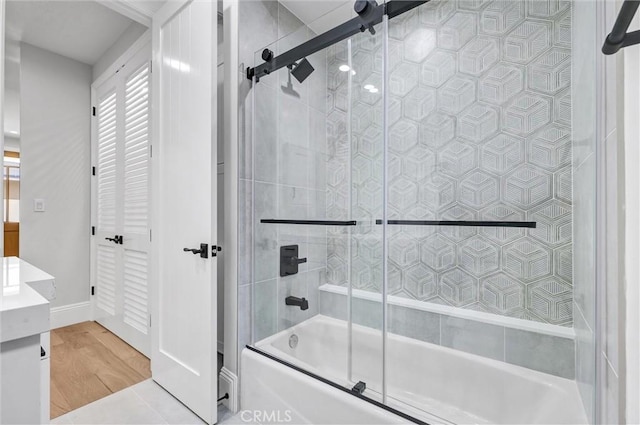 bathroom with vanity, shower / bath combination with glass door, and hardwood / wood-style floors