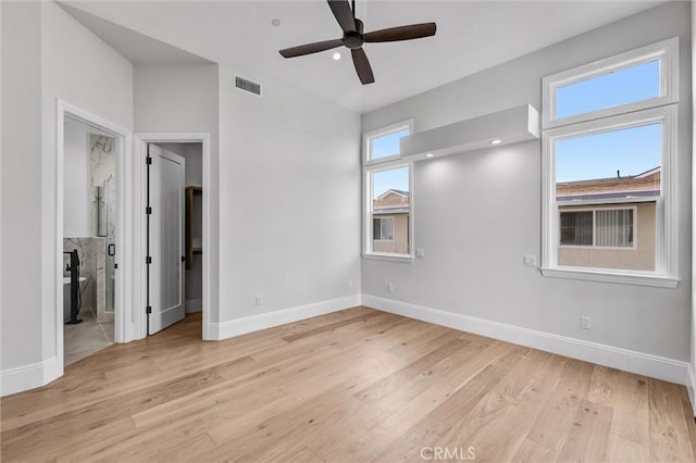 unfurnished bedroom with connected bathroom, ceiling fan, and light wood-type flooring