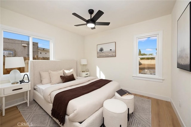 bedroom with ceiling fan and light hardwood / wood-style flooring