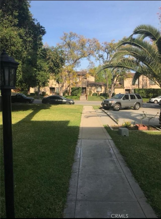 view of property's community featuring a yard