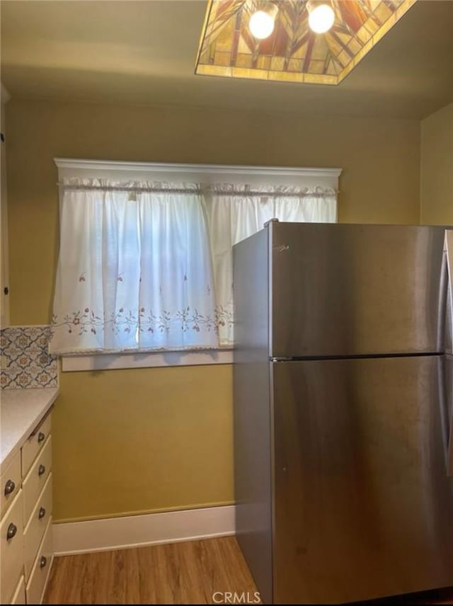 kitchen featuring stainless steel fridge and light wood-type flooring