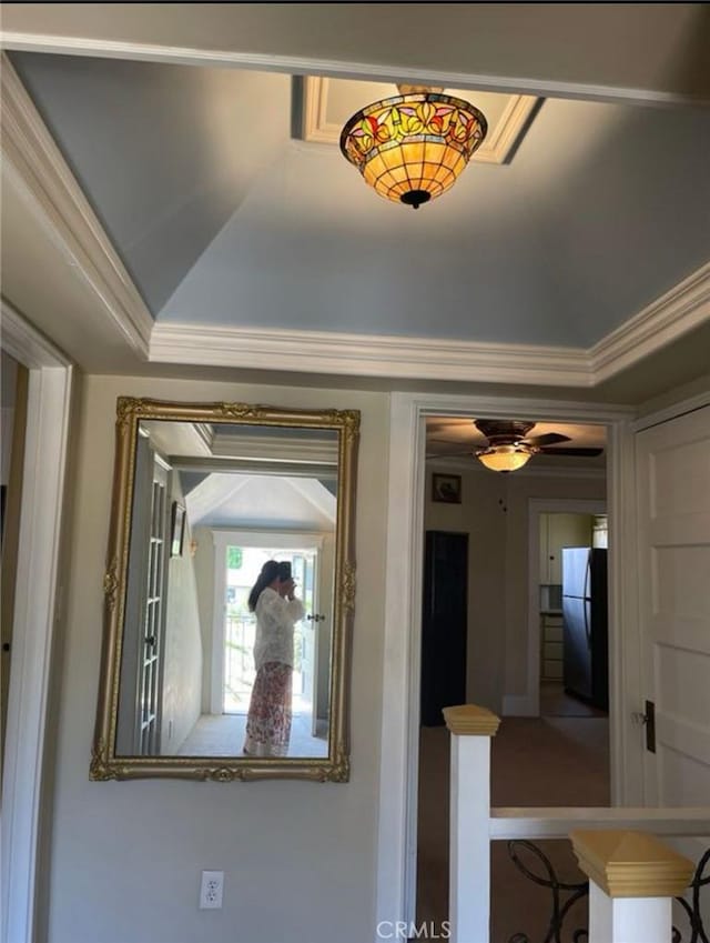 room details featuring black fridge and crown molding