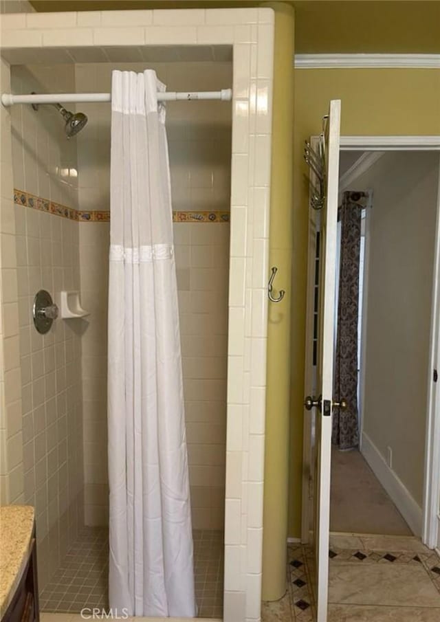 bathroom with tile patterned flooring, vanity, and curtained shower