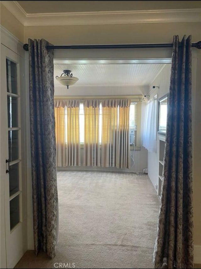 carpeted spare room featuring ornamental molding