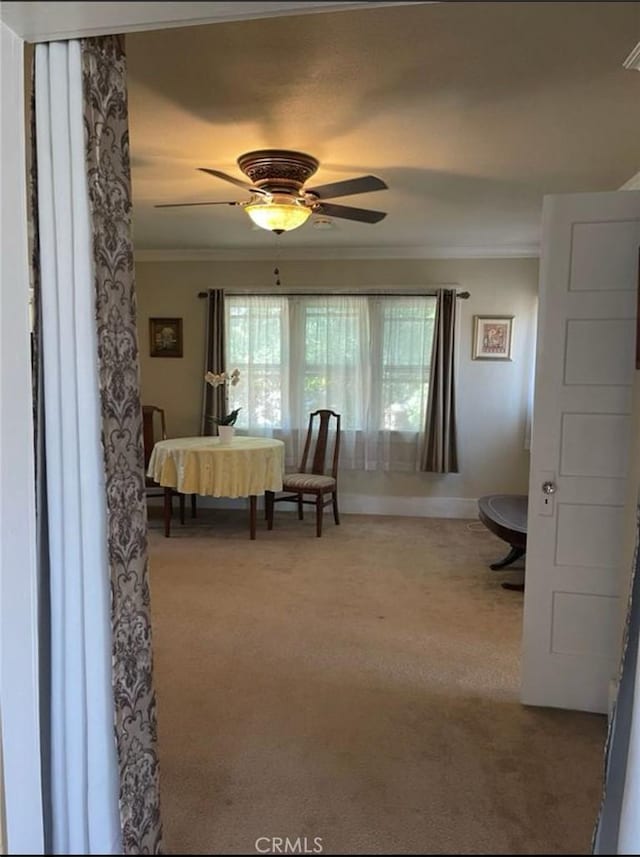 unfurnished bedroom with ceiling fan, ornamental molding, and light carpet