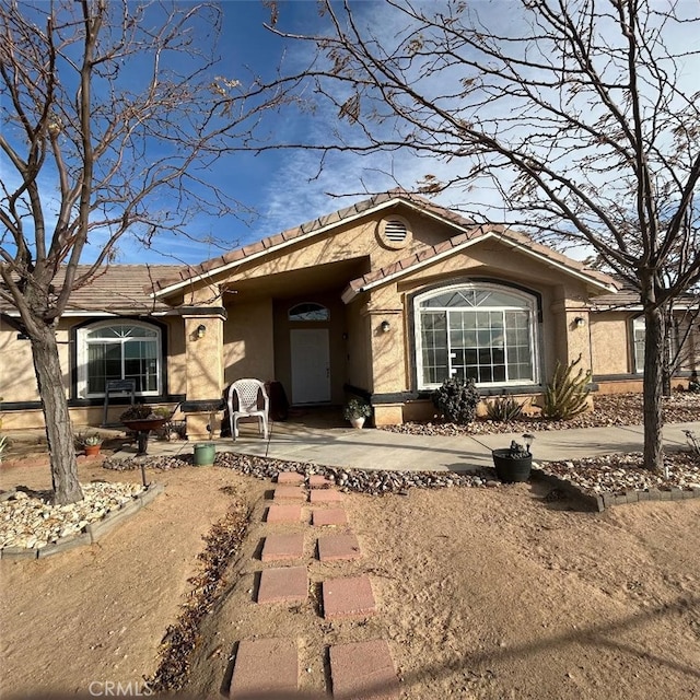 ranch-style home featuring a patio