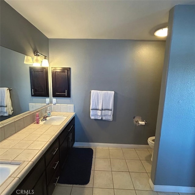 bathroom with vanity, tile patterned floors, and toilet